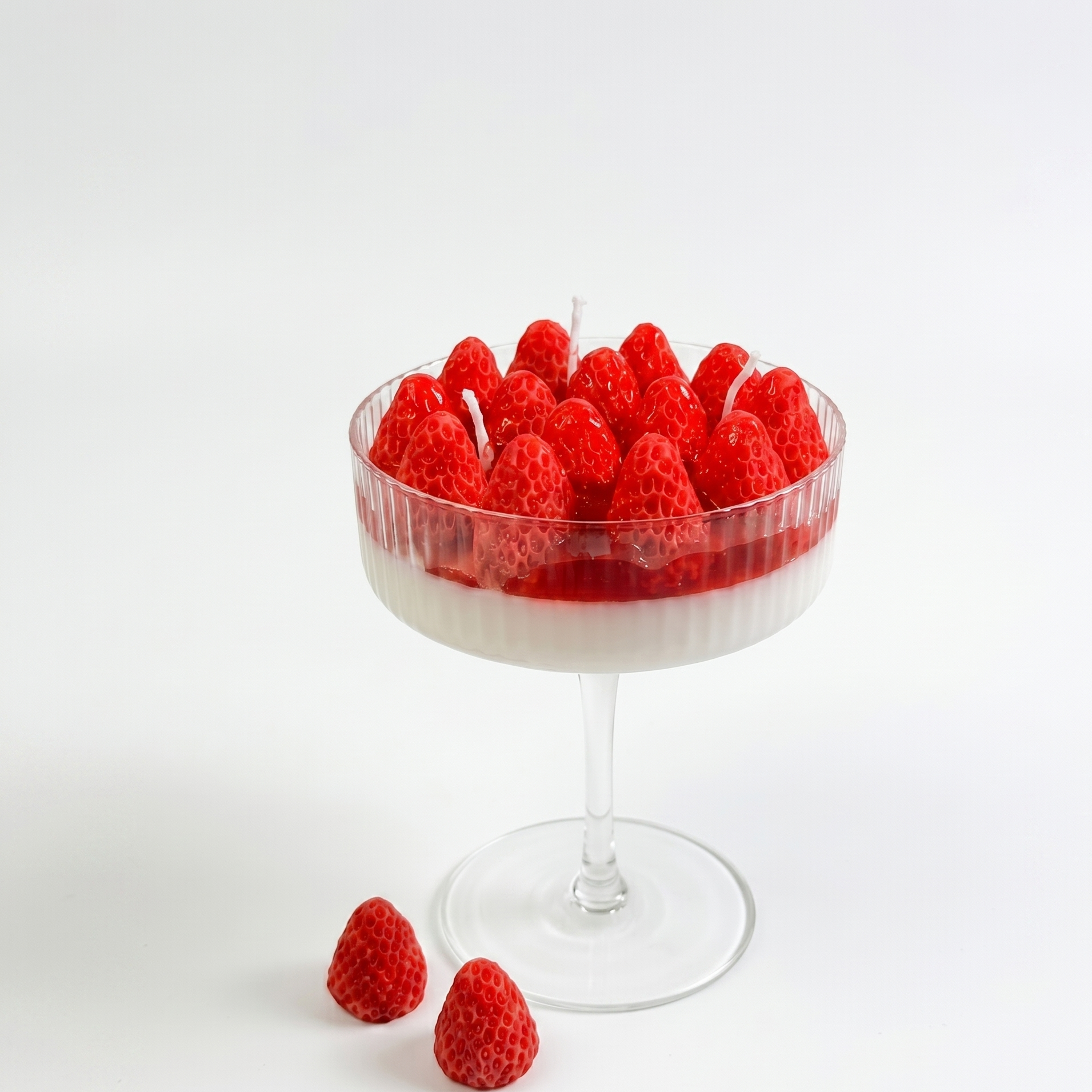 Strawberry scented goblet candle displayed as aesthetic home decor in a modern interior.