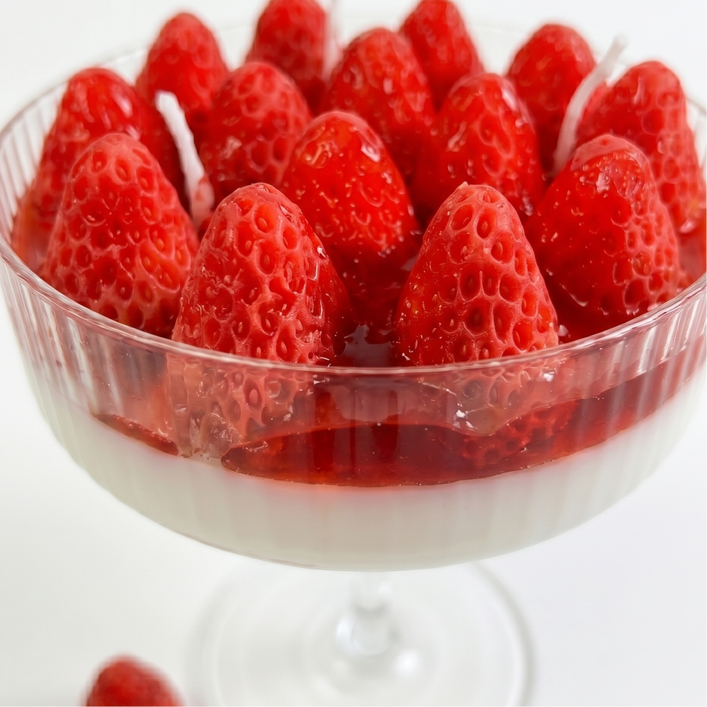 Strawberry scented goblet candle displayed as aesthetic home decor in a modern interior.