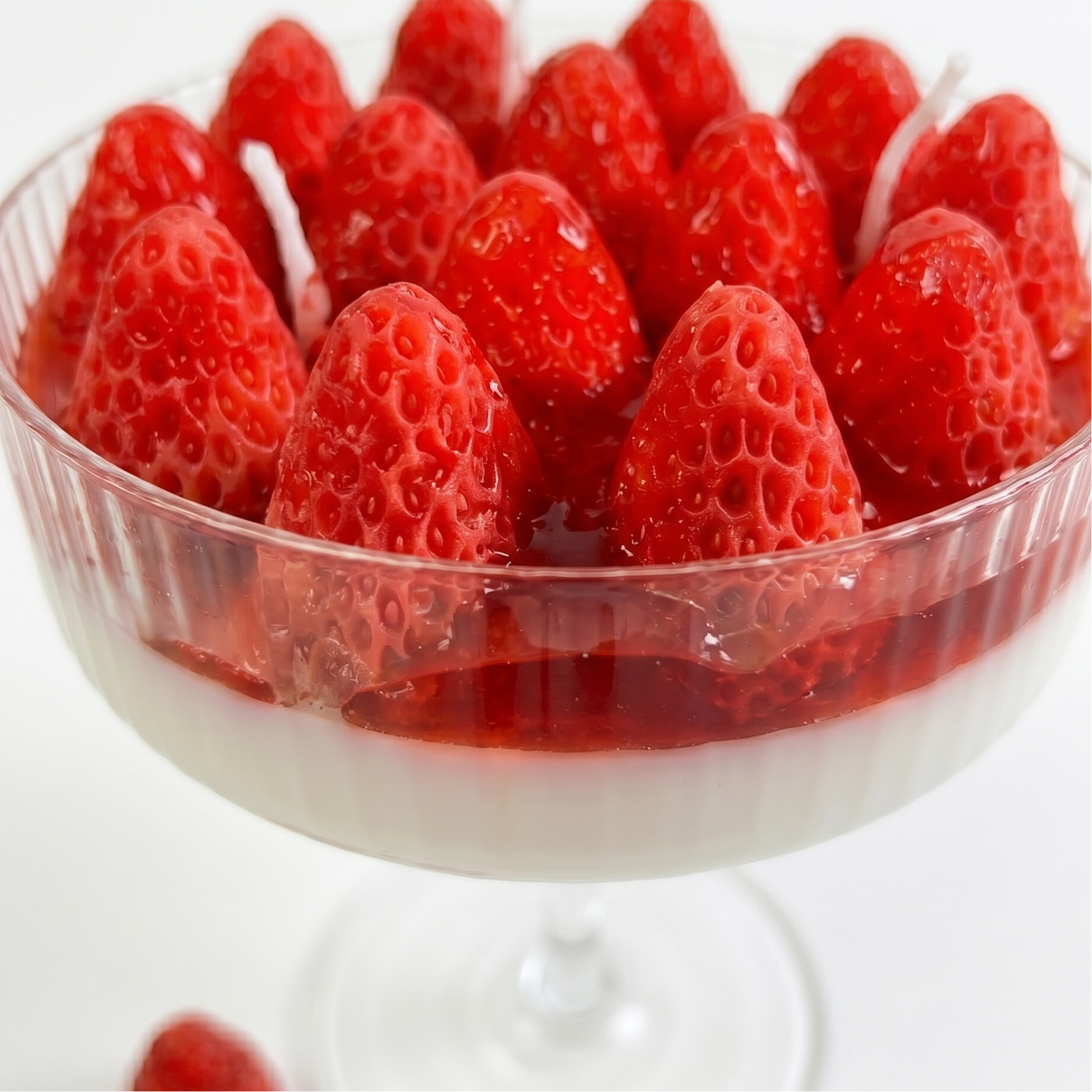 Strawberry scented goblet candle displayed as aesthetic home decor in a modern interior.