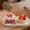shows two handcrafted Mini Pink Strawberry and White Chocolate Donut Candles by SORA SCENT on a clean white background, featuring piped white cream, pink wax berries, and a LOVE letters topping.