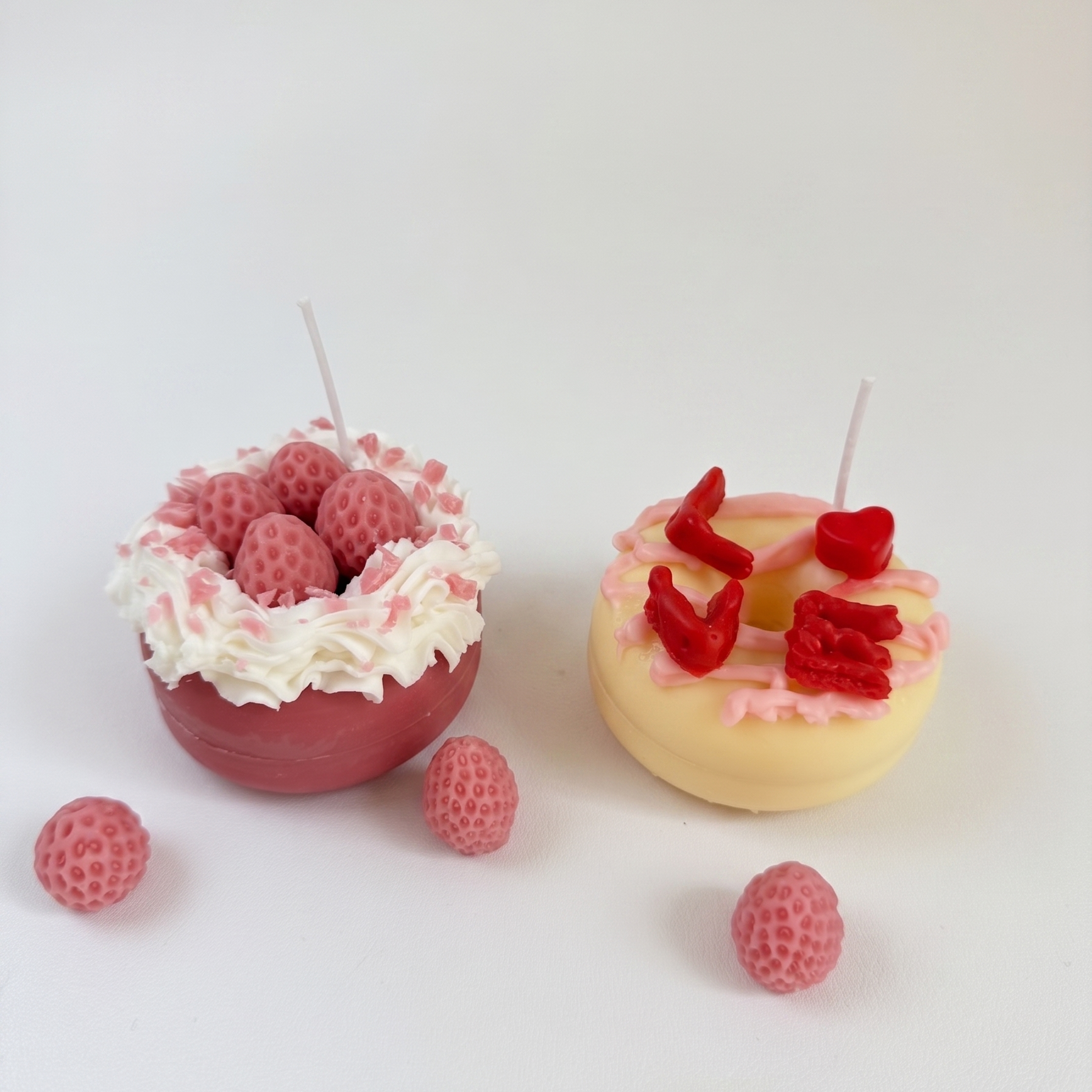 SORA SCENT Mini Pink Strawberry Donut Candle styled on a marble vanity tray next to jewelry and perfume bottles, creating a romantic girly aesthetic.