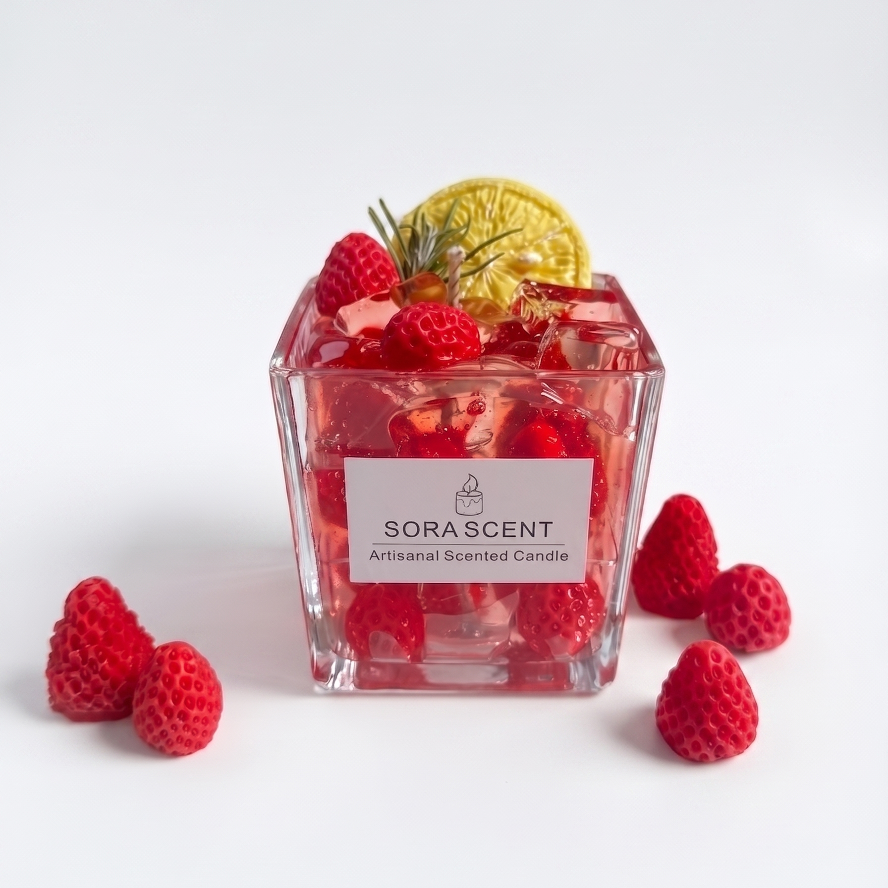 Handcrafted Strawberry Fizz Cocktail Candle by SORA SCENT in a square glass, featuring translucent red bubbling gel wax, embedded wax strawberries, wax ice cubes, and a lemon slice garnish.