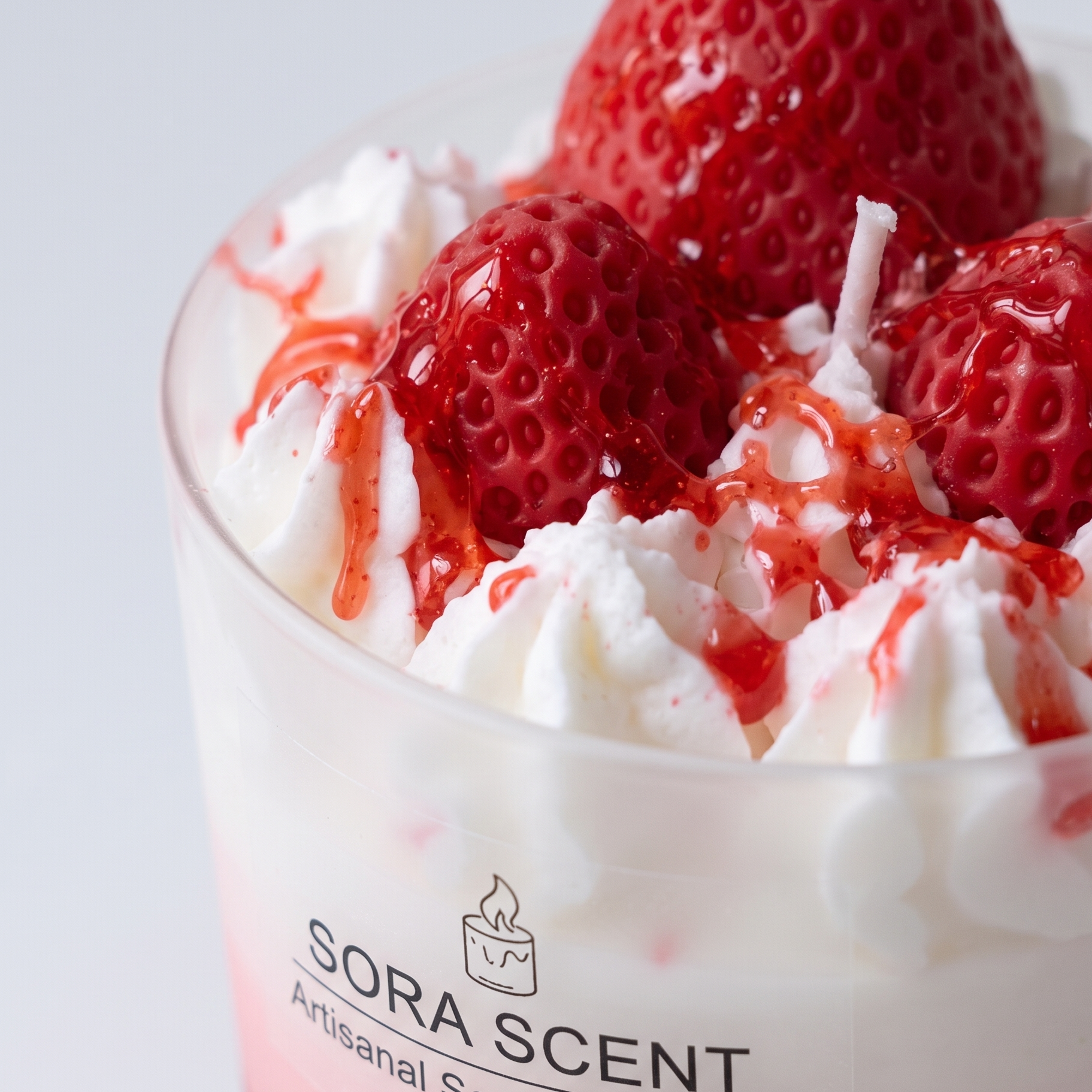 Macro close-up shot of SORA SCENT's Strawberry Raspberry Panna Cotta Sundae Candle, highlighting the bumpy seed textures of hand-sculpted wax berries, glossy fruit syrup drizzles, and hand-piped white whipped soy cream.