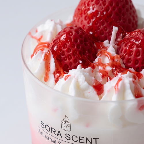 Macro close-up shot of SORA SCENT's Strawberry Raspberry Panna Cotta Sundae Candle, highlighting the bumpy seed textures of hand-sculpted wax berries, glossy fruit syrup drizzles, and hand-piped white whipped soy cream.