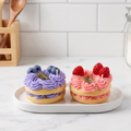 sora-scent-mini-berry-macaron-candles-white-background.jpg` | SORA SCENT Mini Lavender and Strawberry Macaron Candles on a clean background, showcasing their golden macaron bases, piped soy whipped cream, and realistic blueberries and raspberries. 